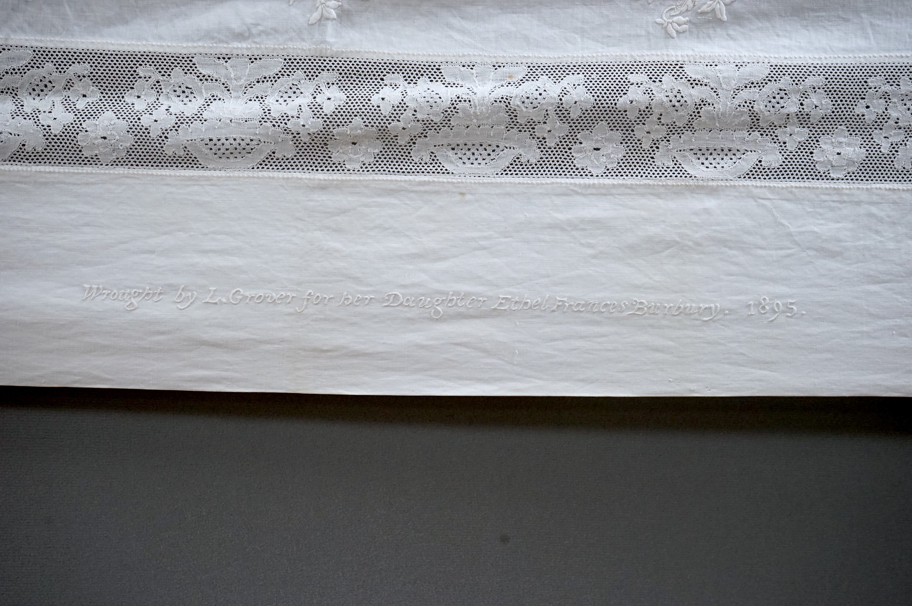 An unusual Victorian white linen hand worked table cloth. Embroidered along one edge, Wrought by L. Grover for her daughter Ethel Frances Burbury 1895. Together with three crochet edged cloths and a circular embroidered
